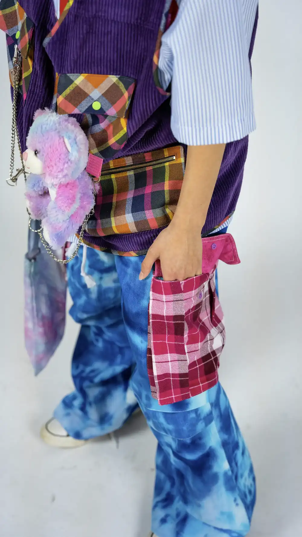 Female model wearing TRKSTR Multi Utility Vest and TRKSTR Baggy Tie Dye Cargo Pants